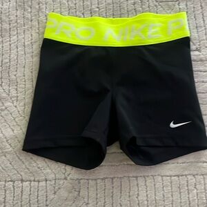 Black Nike Pros with neon green waistband
